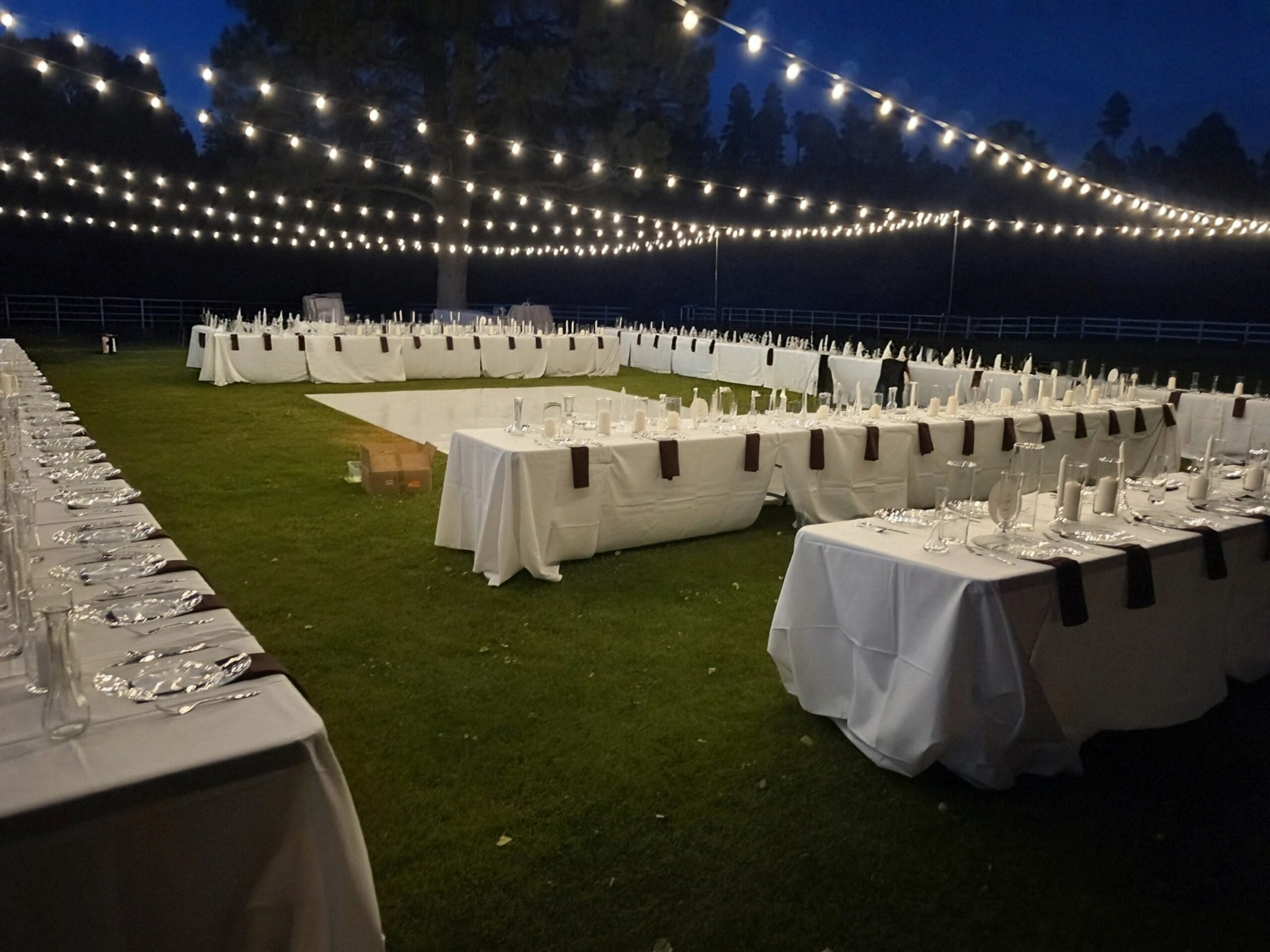 Complete event rental package setup with lighting, tables, chairs, and dance floor