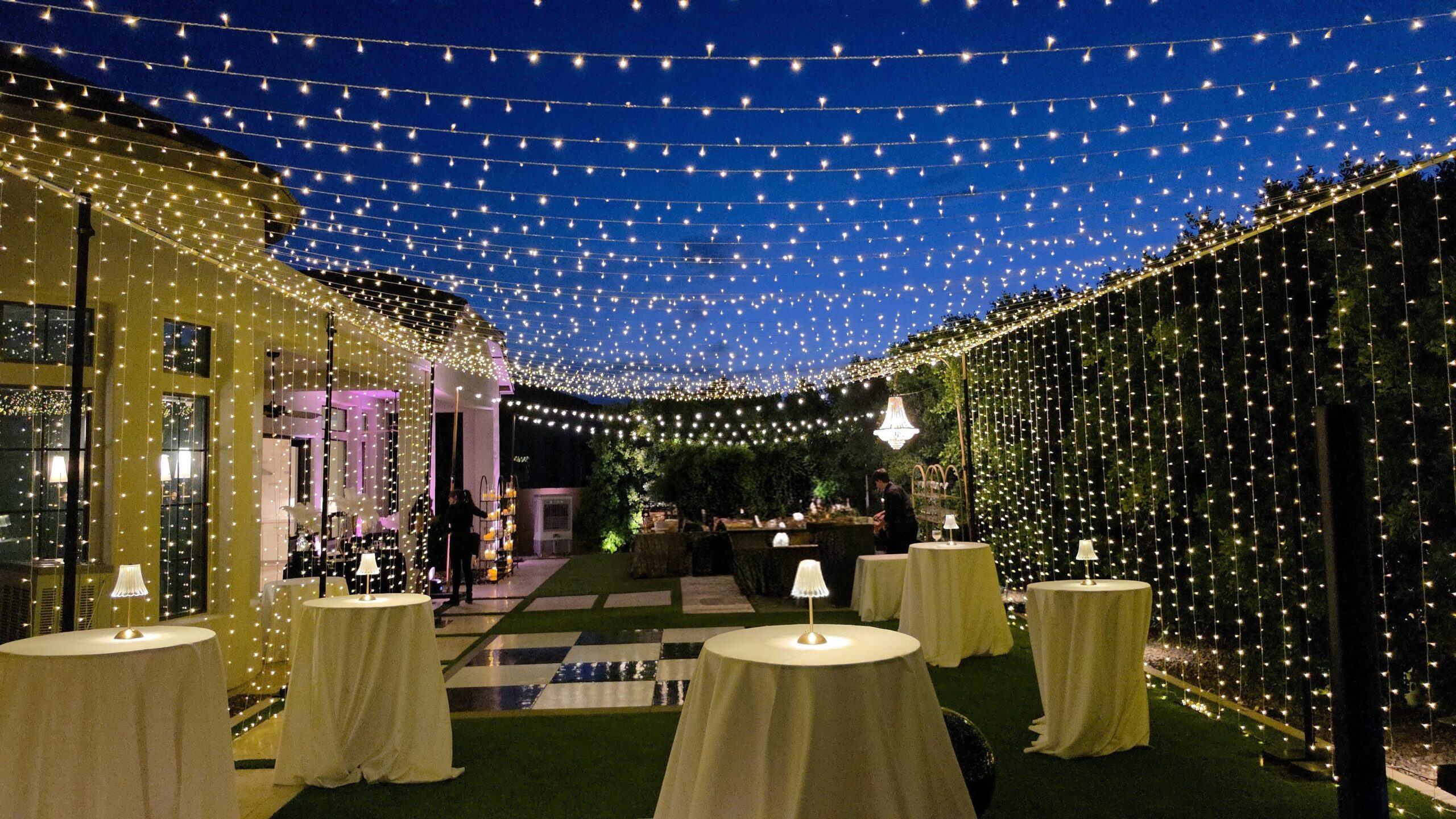 Backyard twinkle light canopy with dance floor for a private event in Phoenix Arizona